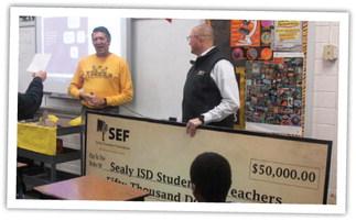 ABOVE: Dr. Bryan Hallmark and the Sealy Education Foundation Prize Patrol surprise Sealy Junior High teacher Valentine Eschenburg with a grant. BELOW: Fine arts students at the Sealy Junior High gathered around SEF prize patrol members during the grant presentation. PHOTOS BY JIMMY GALVAN