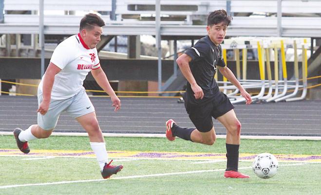 Sealy senior Abraham Palencia looks to make a pass during the Tigers’ home district finale against Bellville on March 8. Palencia scored two goals last Friday to help advance Sealy to the fourth round of the playoffs for the first time in program history. COLE McNANNA