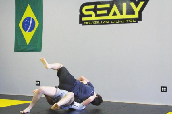 Conner Bilyeu and Joseph Barnett spar at the Sealy Brazilian Jiu-Jitsu dojo that officially opened in December at the Outlet Center Mall in Sealy. Call 281-785-9000 or email sealybjj@gmail.com for more information. (Cole McNanna/Sealy News)