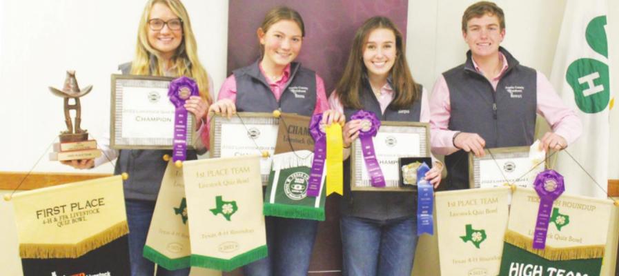 Brooke Diezi, Emma Eckelberg, Morgan Hesters and Stewart Poffenberger posed with awards they had collected throughout their two undefeated years of competition as a 4-H Livestock Quiz Bowl team. HANS LAMMEMAN