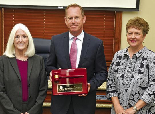 Chancellor Dr. Mary Hensley (left) and new Board Chair Allison Bentke (right) present Trustee Jim Kolkhorst with a plaque recognizing his four years of service as Chair of the Blinn College District Board of Trustees.