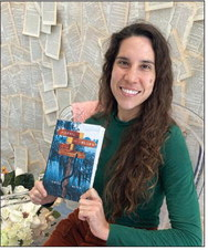 Author Ariel Slick holds up a copy of her Southern Gothic novel “The Devil Take the Blues.” COURTESY OF THE STORY PEDDLER