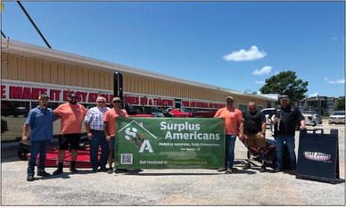 Surplus Americans representatives posing with the Cliff Jones team. Pictured From left to right: Jay McClain, Hunter Bruce ((Founder-SA), Jim Pursley (Owner-Cliff Jones), Jaymes Knox, Jason White (Founder-SA), Travis Green, Shawn Brennan &amp; the dog is Pearl
