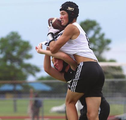 Sealy receiver Tanner Ellis steals a reception away from a Jordan defender for a touchdown in the Tigers’ final game of the Taylor passing league at James E. Taylor High School in Katy Wednesday, June 30. PHOTOS BY COLE McNANNA
