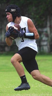 Sealy receiver Bradley Garbs reels in a pass during the Tigers’ contests against Jordan Wednesday, June 30, at James E. Taylor High School.