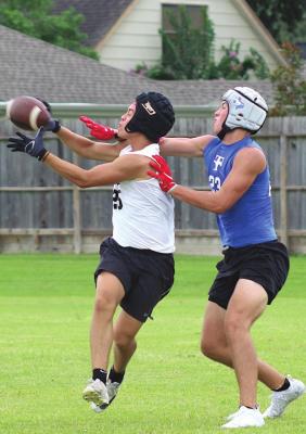 Tiger senior Julius Aguilar completes a contested catch during Sealy’s 7-on-7 game against Taylor in Katy Wednesday, June 30.