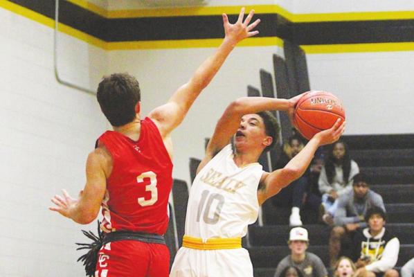 COLE McNANNA Sealy freshman Noah Washington battles Columbus junior Colton Pitchford at the rim during the non-district contest at Sealy High School Dec. 14, 2021. Washington twice scored double digits for the Tigers in tournament action last week.