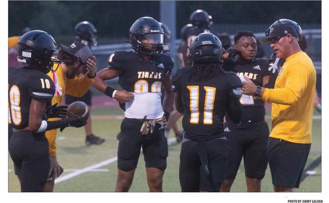 Sealy Head Football Coach Clint Finley talks with his receiving corps before la_