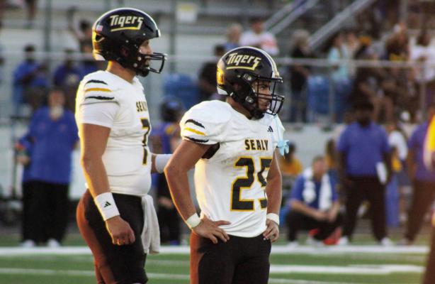 Sealy’s Kane Killough and Romeo Castillo look to the sideline for a play call during last Friday loss to Bay City. Sealy will look to move back to the win column this Friday when the Tigers host Needville.
