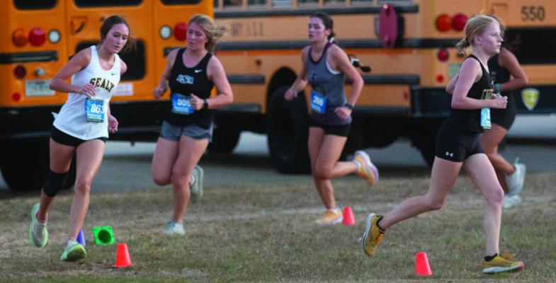 Sealy’s Jacie Kainer rounds the corner during last Friday’s Friday Night Lights meet held at Sealy High School. PHOTO BY JIMMY GALVAN