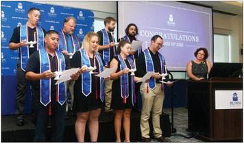 Graduates of Blinn’s Paramedic-to-RN Program Class of 2023 recite the Florence Nightingale Pledge during their pinning ceremony at the Blinn RELLIS Administration Building. Top row (left to right): Tyler Vitek, Mark Rosenbaum, Parker Arrants, and Brandon Beck. Front row (left to right): Ramiro Gutierrez, Krysten Lerchbacker, Makayla Hallman, and Steven Shimerka. At the podium: Associate Degree Nursing Program Faculty Jaime Hardy. CONTRIBUTED PHOTO