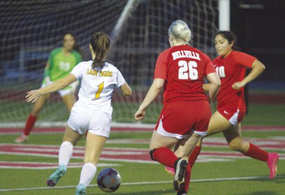 #1 junior forward Avery Schalla takes on two Bellville defenders in front of goal. PHOTOS BY ABENEZER YONAS