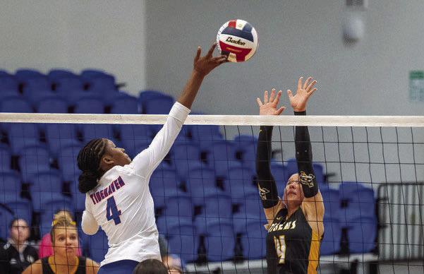 Sealy’s Avery Grigar goes up for a block attempt during a contest last season.