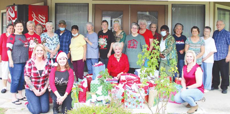 TOP: The Oaks retirement community members rounded up to receive Angel Tree gifts to spread holiday cheer Thursday afternoon in Sealy.