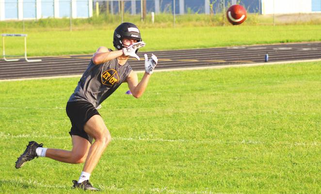 Parker DeBerry looks in a catch during a drill on the first day of football practice at Sealy High School Monday morning. COLE McNANNA