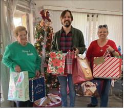 The Frydek Catholic Daughters, Court Our Lady of Faith #2607, recently lifted the Christmas spirits for about 100 residents of the Silver Lake and The Oaks Retirement Homes in Sealy. CDA members of the court filled bags of goodies for each one. Delivering the gifts to Director Andrew Tirey (center) are on Regent Doris Sodolak, left, and Judith Washburn, right. COURTESY PHOTO
