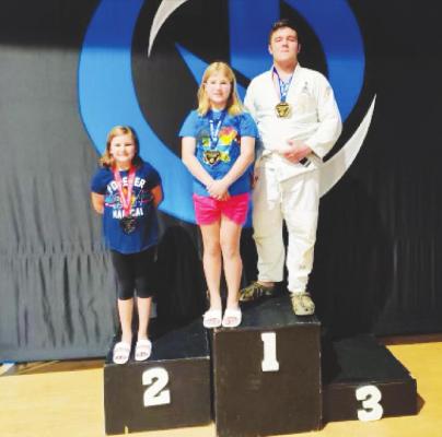 Luke Richards and Lydia Clark earned gold medals, and Zoe Clark won silver, from the Grappling Games’ Houston Summer Games at The Zone last weekend. COURTESY PHOTOS