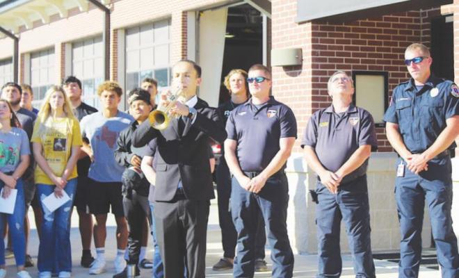 Wyatt Martinez played taps at the Saturday morning gathering at the flagpole outside the Sealy Fire Station as part of 20th-anniversary events Sept. 11.