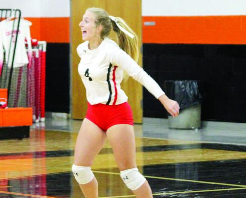 Freshman Bayleigh Marek leaps up to block a ball. SEALY NEWS | EVAN HALE