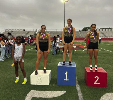 ara Kram (1st place), Mya Torres (2nd place) and Callie Whatley (3rd place) on the podium after their 100m hurdle race. COURTESY PHOTO