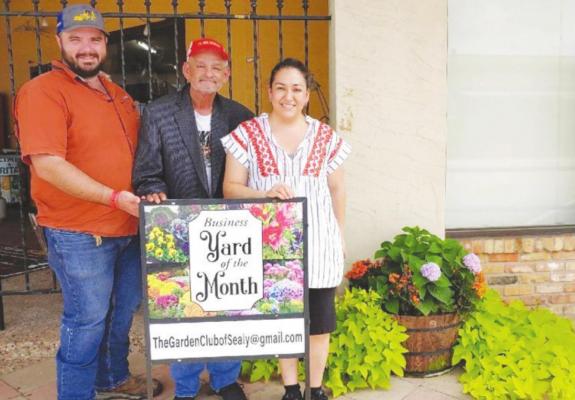 The Garden Club of Sealy’s Business Yard of the Month for July was chosen as San Juan Meat Market &amp; Taqueria at 102 Main Street. Accepting the recognition are Nicholas Nelson, Rueben and Sarah Zavala.
