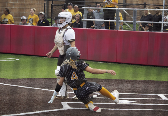 Avery Grigar slides into home plate to score a run for the Lady Tigers against Giddings. SEALY NEWS | EVAN HALE