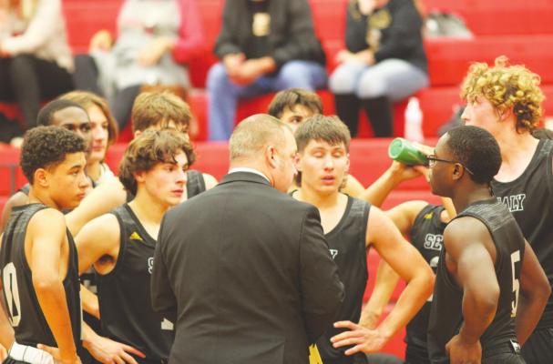 Sealy Tiger Head Basketball Coach Cody Carruthers meets with his team during the Nov. 30 season opener on the road against the Columbus Cardinals. CONTRIBUTED BY TRENTON WHITING/COLORADO COUNTY CITIZEN