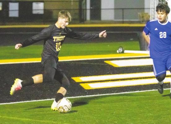 Tiger junior Tanner Ellis looks to send a ball inside the box in the first half of Sealy’s district tilt against Discovery on Mark A. Chapman Field Jan. 28. Ellis scored a goal and assisted on the final goal last Friday night. PHOTOS BY COLE McNANNA