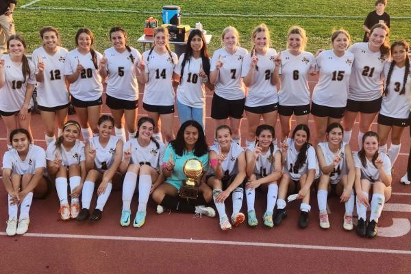 The Sealy Lady Tigers gather around the bi-district trophy after defeating Booker T. Washington last Friday night at Dyer Stadium. Sealy was set to take on Hamshire-Fannett Tuesday night in Huffman. The results of the game were not available at press time. PHOTO BY JIMMY GALVAN