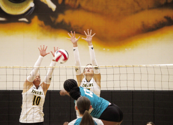 Jade Barton (left) and Lauren Luther combine their efforts to block a ball at the net. SEALY NEWS | EVAN HALE