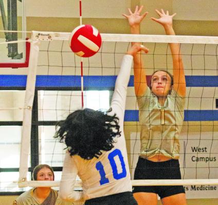 Sealy’s Ansley Owen goes up for a block during last Friday’s win over Royal. PHOTO BY JIMMY GALVAN