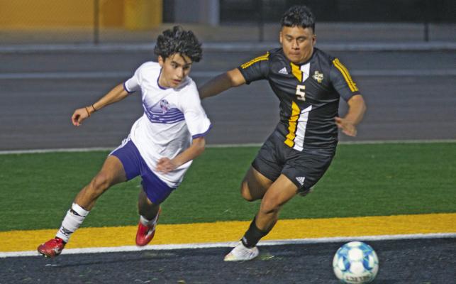 Sealy’s Jovanni Guerrero battles a Harmony player for a loose ball. PHOTOS BY JIMMY GALVAN