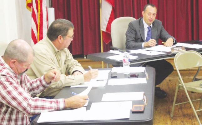 Precinct 4 Commissioner Chip Reed discussed with County Judge Tim Lapham the safety benefits of a concrete structure accompanying the weigh station on Interstate 10. HANS LAMMEMAN