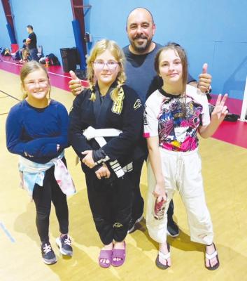 Sealy Brazilian Jiu Jitsu’s Lydia Clark and Aprillia Singer recently competed in the Houston Fall Championships presented by Battleground Saturday, Nov. 6, and came away with three silver medals. They are pictured with Zoe Clark, left, and Sealy BJJ Coach Ken Amador. COURTESY PHOTO