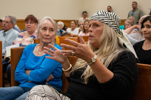     Bridget Kourik (right) questions CleanSpark representatives during public comment for a moratorium on data centers during Austin County Commissioners Court, Monday, July 27, in Bellville. 