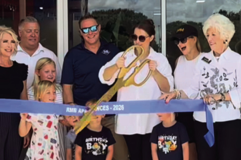 From left: Claudia Batton, Vince Wollney, owner Ross McDowell, owner Mary Beth McDowell and Toni Franklin cut the ribbon as family friend and youngsters look on at the June 12 grand opening of RMB Appliances in Sealy. COURTESY PHOTOS
