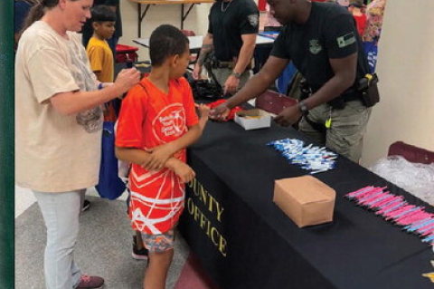 Members of the Austin County Sheriff’s Office and Youth and Family Services served the community during the Back-To-School Fair last week at Bellville High School. COURTESY PHOTO