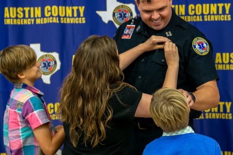 Daniel Owens is pinned as Clinical Chief of Austin County EMS by children.