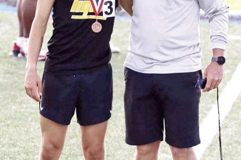 Gavin Almaguer sports his medal with Sealy Track Coach Val Eschenburg after his race. PHOTO BY WILSON CHANEY